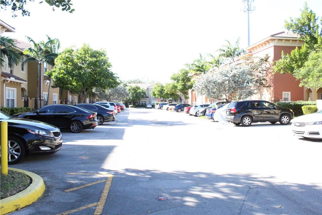 2851 Prospect Road, Unit 405 Tamarac, FL 33309 - Photo 22 of 25 a cars parked on the side of a street