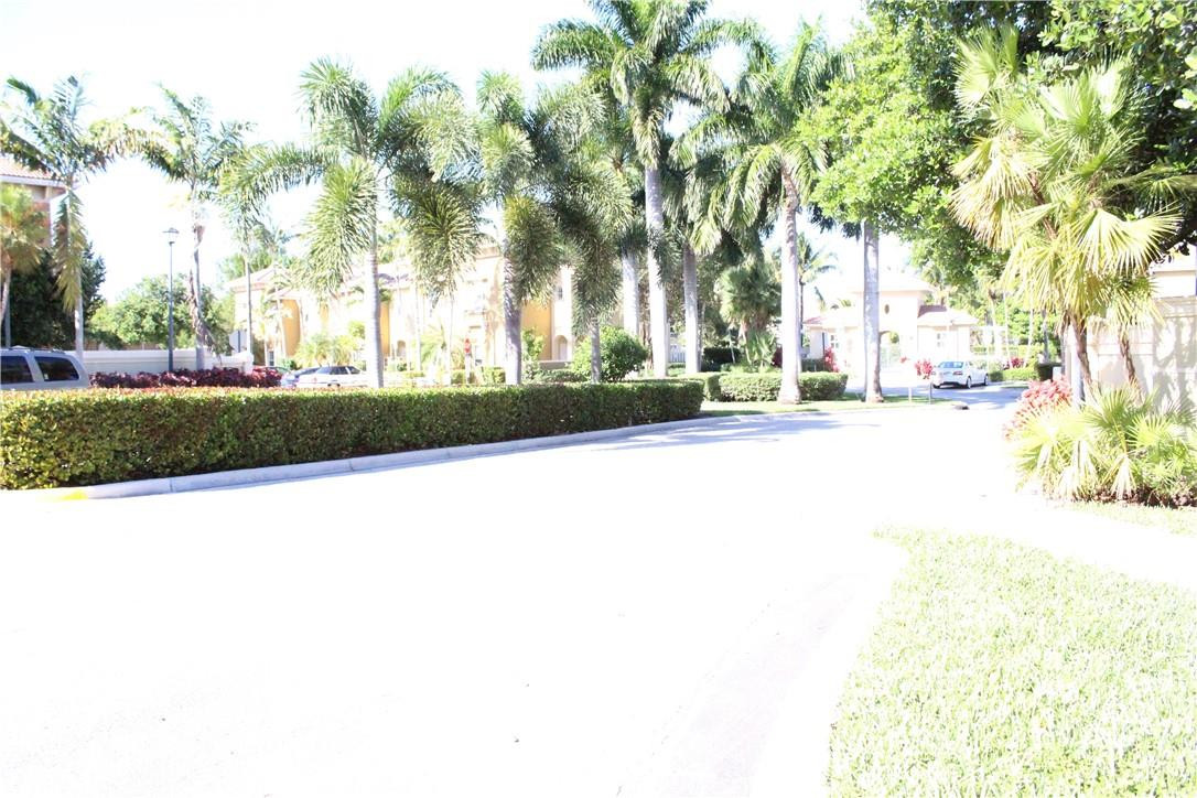 2851 Prospect Road, Unit 405 Tamarac, FL 33309 - Photo 23 of 25 a street view with large trees