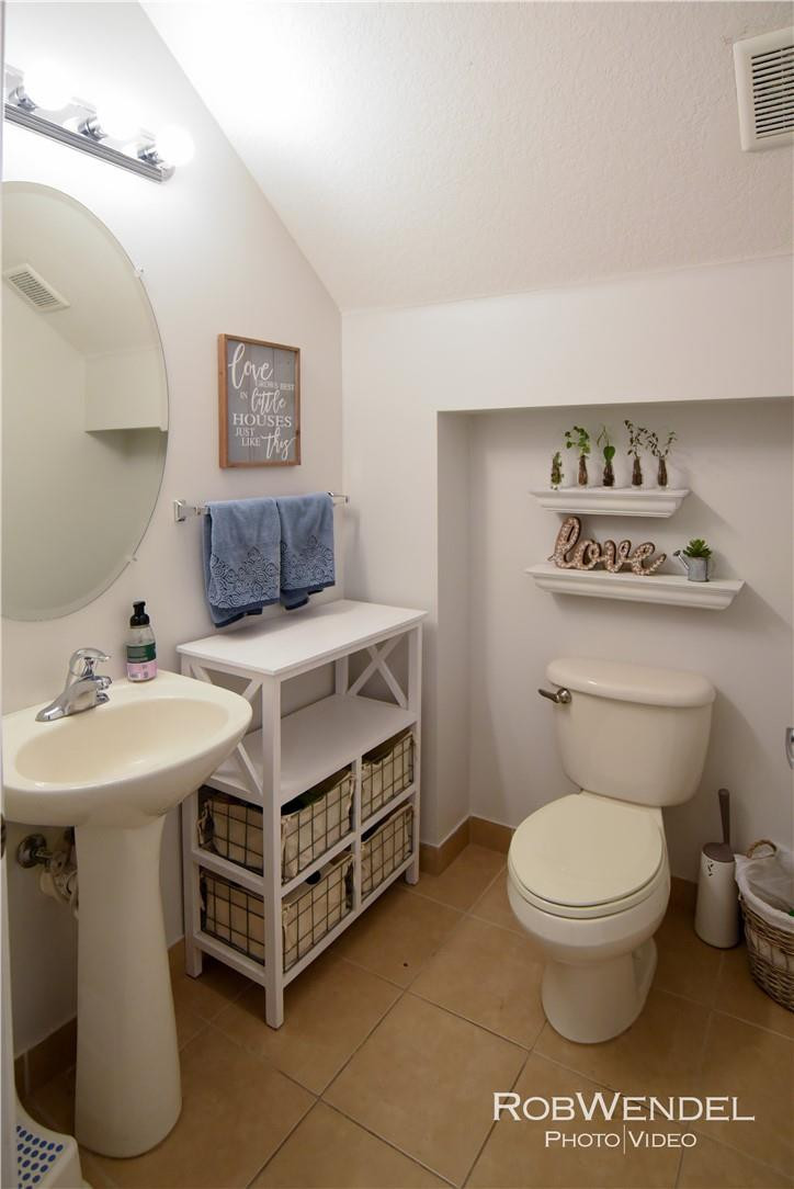 2851 Prospect Road, Unit 405 Tamarac, FL 33309 - Photo 4 of 25 a bathroom with a sink a toilet and mirror