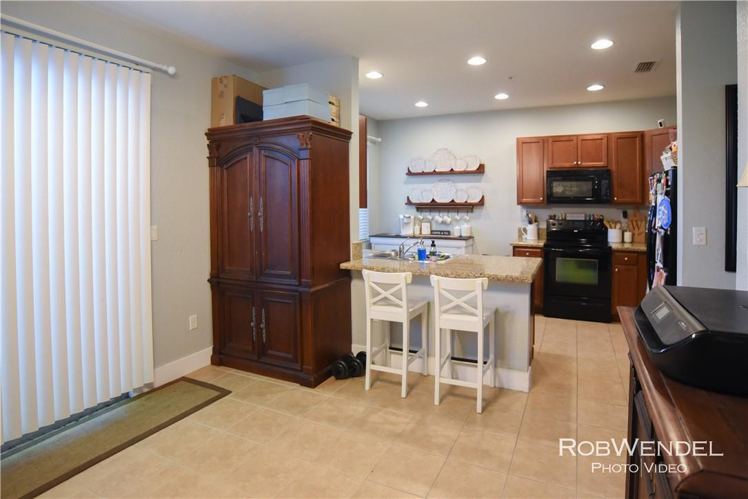 2851 Prospect Road, Unit 405 Tamarac, FL 33309 - Photo 6 of 25 a kitchen with stainless steel appliances granite countertop a refrigerator and a stove top oven