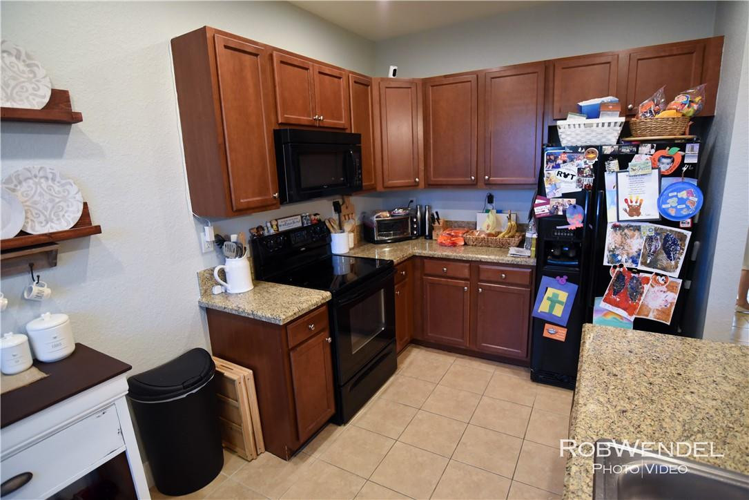 2851 Prospect Road, Unit 405 Tamarac, FL 33309 - Photo 7 of 25 a kitchen with a sink and a stove top oven