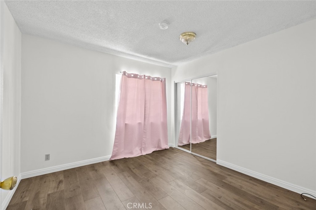 10528 1/2 Hillhaven Avenue Tujunga, CA 91042 - Photo 13 of 28 a view of a room with wooden floor and fan