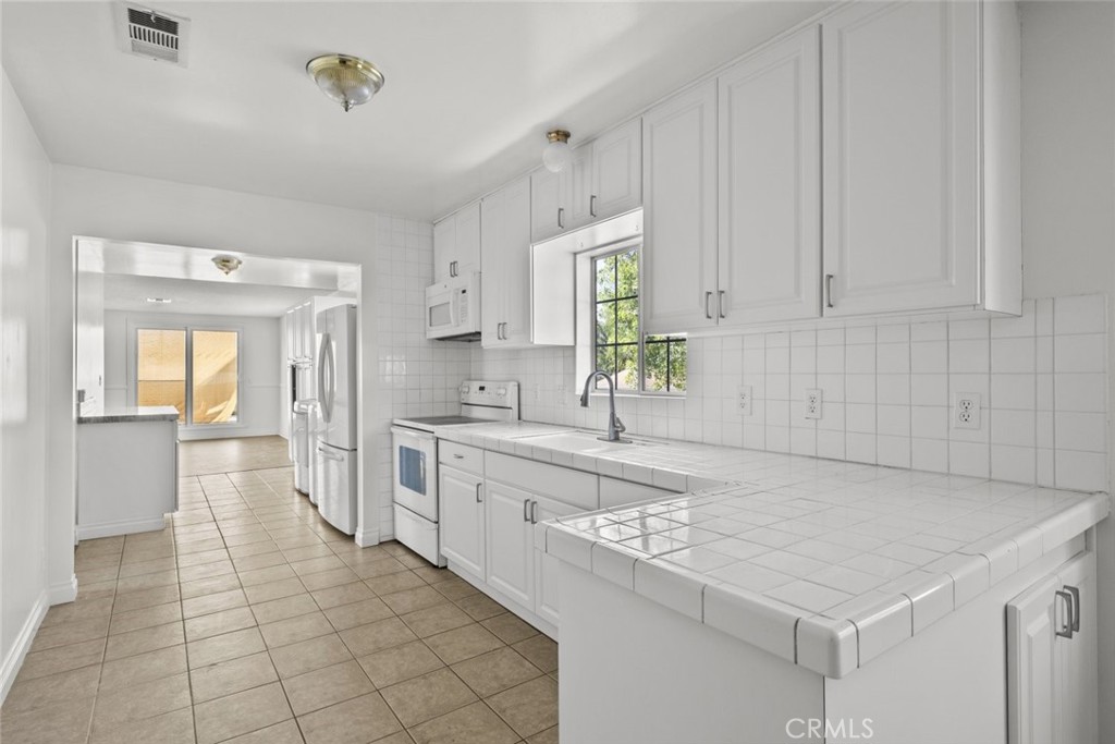 10528 1/2 Hillhaven Avenue Tujunga, CA 91042 - Photo 16 of 28 a kitchen with a sink cabinets and window