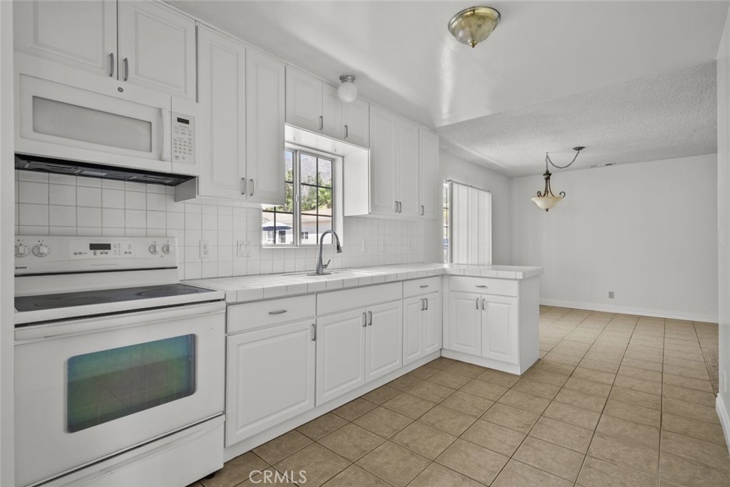 10528 1/2 Hillhaven Avenue Tujunga, CA 91042 - Photo 17 of 28 a kitchen with cabinets appliances and a sink