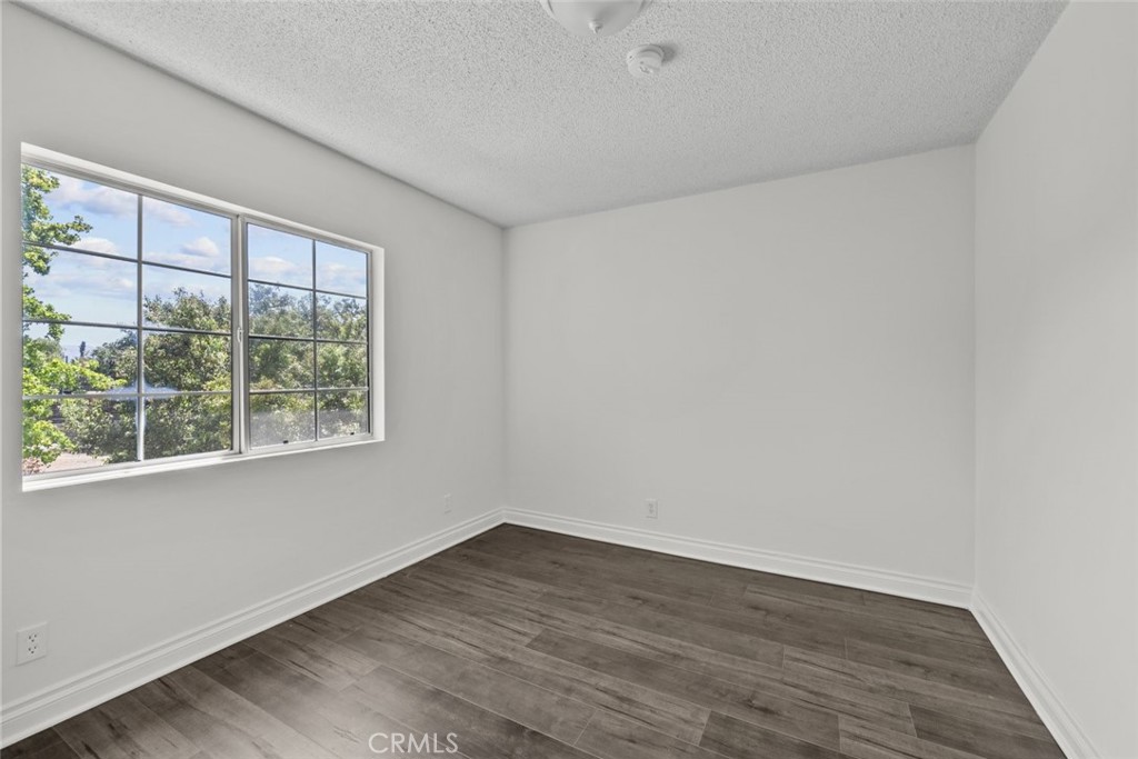 10528 1/2 Hillhaven Avenue Tujunga, CA 91042 - Photo 18 of 28 wooden floor in an empty room with a window