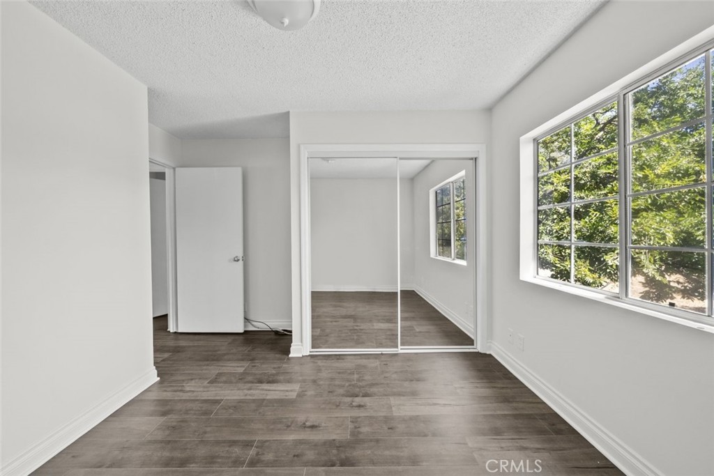 10528 1/2 Hillhaven Avenue Tujunga, CA 91042 - Photo 19 of 28 an empty room with wooden floor and windows