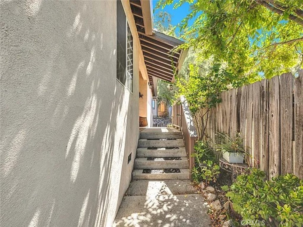 10528 1/2 Hillhaven Avenue Tujunga, CA 91042 - Photo 2 of 28 a view of a pathway of a house with wooden fence and trees
