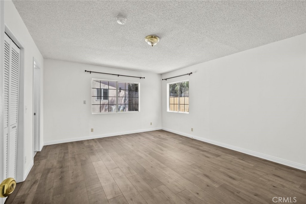 10528 1/2 Hillhaven Avenue Tujunga, CA 91042 - Photo 8 of 28 an empty room with wooden floor and windows