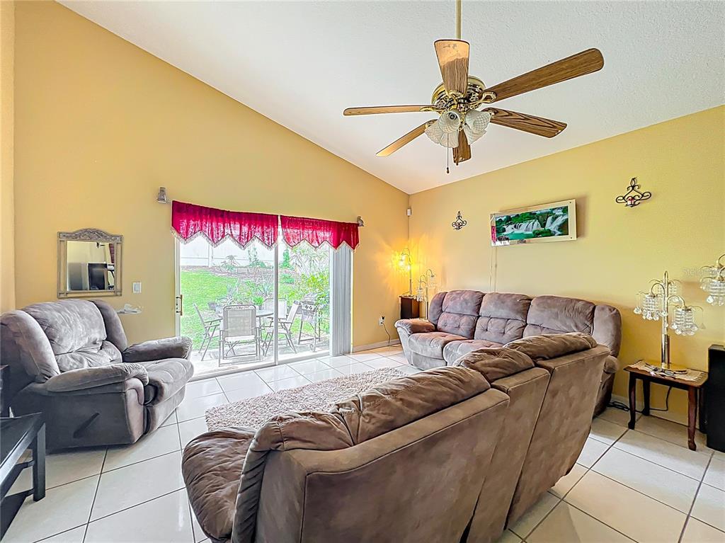 7939 Riffle Lane Orlando, FL 32818 - Photo 15 of 52 a living room with furniture and a large window