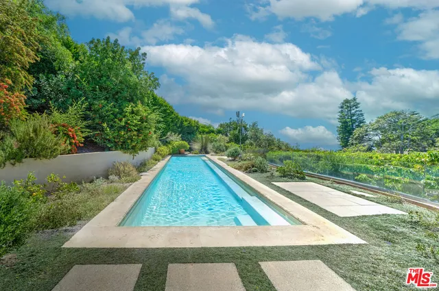 an empty room with floor to ceiling windows and a fireplace