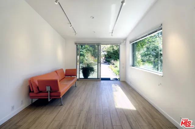 a view of backyard of house with green space