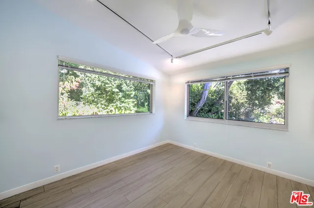 a kitchen with a stove a sink and cabinets