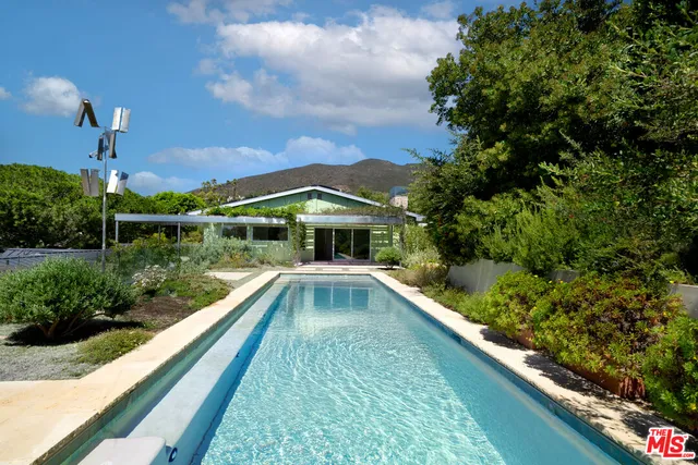 a large kitchen with kitchen island a stove a sink and a refrigerator