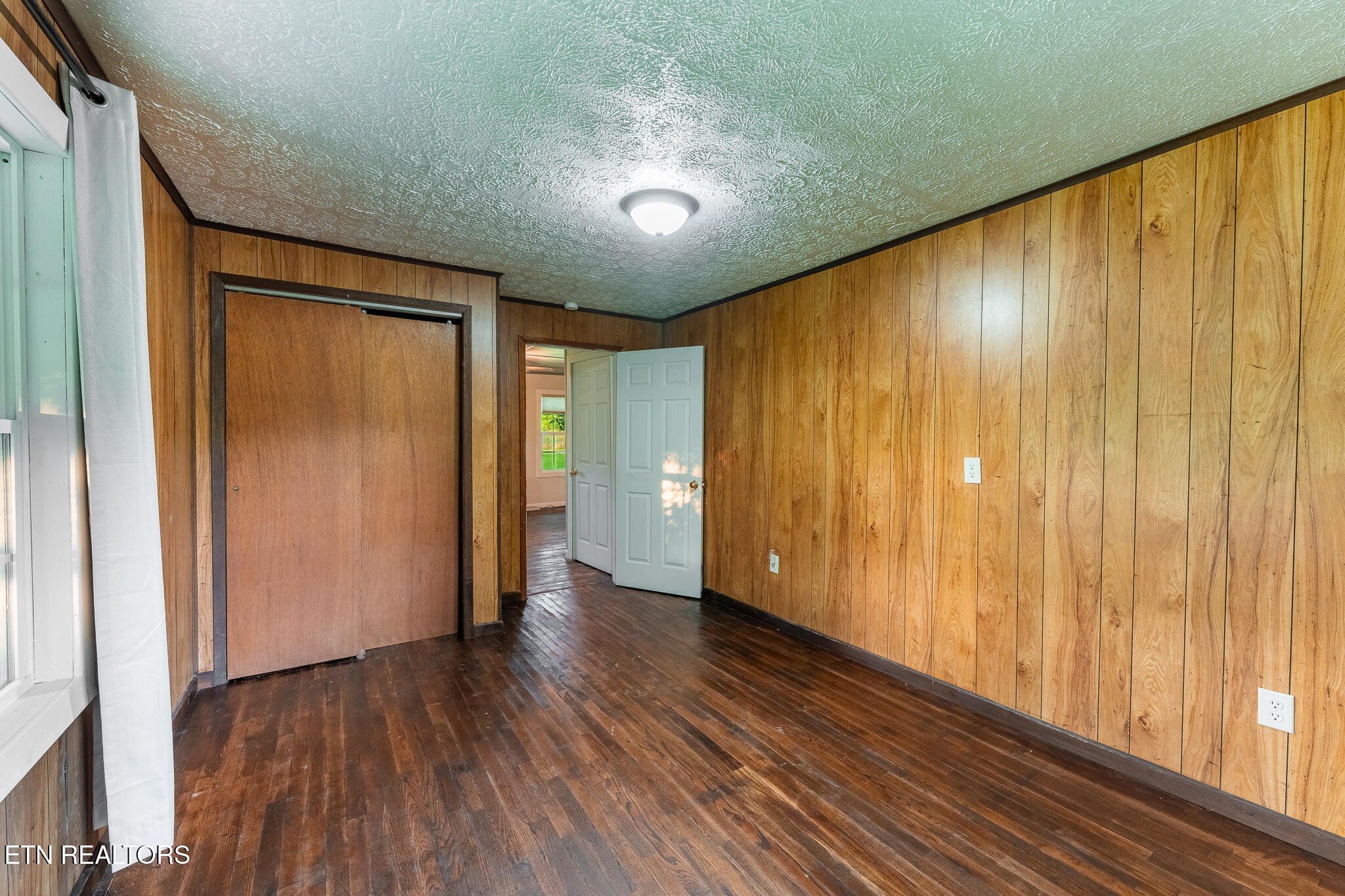 2530 Roslin Road Deer Lodge, TN 37726 - Photo 24 of 58 a view of an empty room with wooden floor and a window