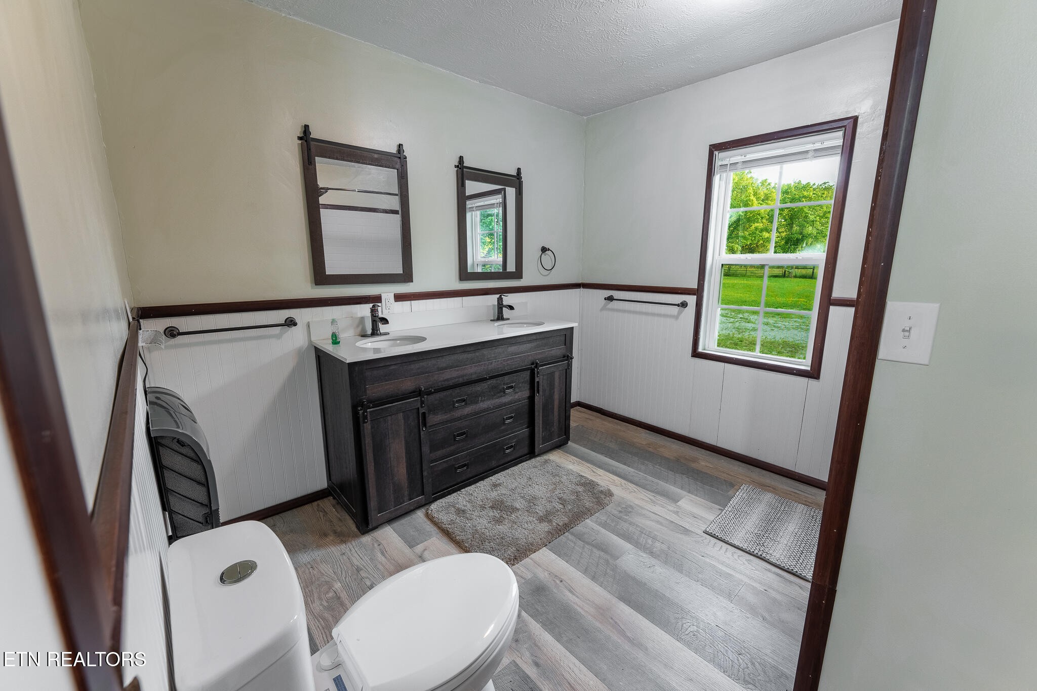 2530 Roslin Road Deer Lodge, TN 37726 - Photo 25 of 58 a bathroom with a granite countertop sink toilet and mirror