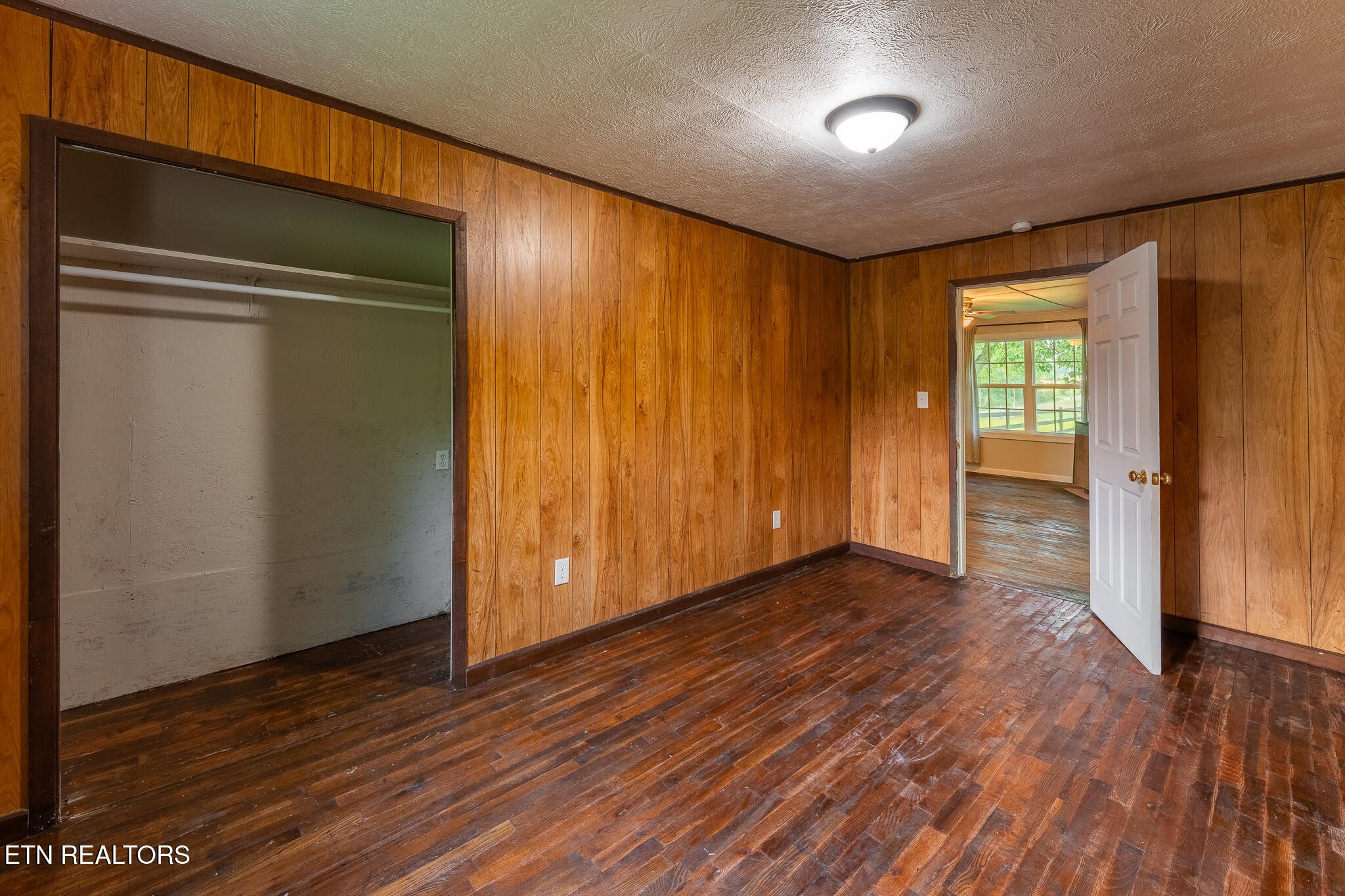 2530 Roslin Road Deer Lodge, TN 37726 - Photo 28 of 58 an empty room with wooden floor and windows