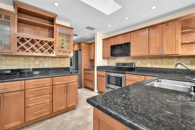 a stove top oven sitting inside of a kitchen