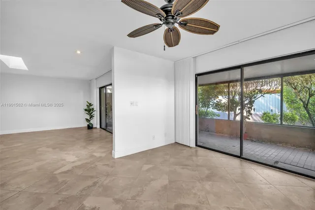 a view of an empty room with a kitchen