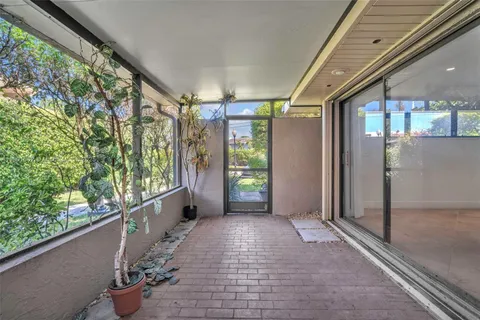 a view of a patio with swimming pool table and chairs