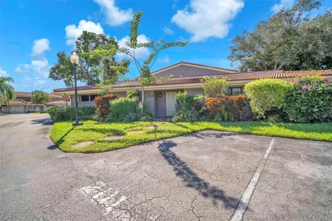 a view of a house with a backyard and a garden