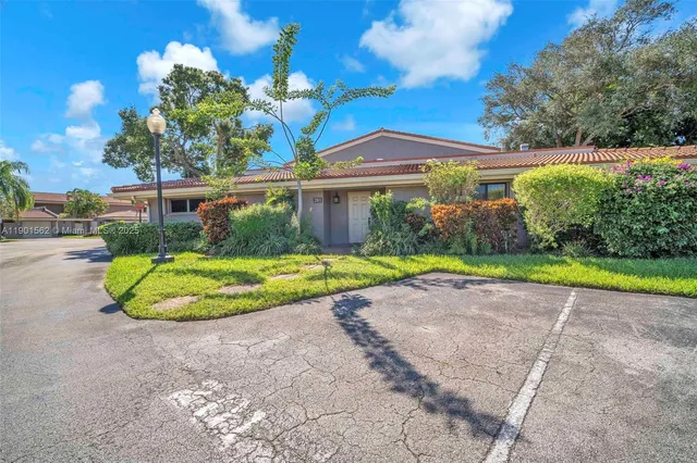a view of a house with a backyard and a garden
