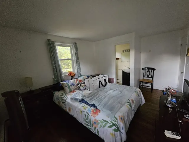 a bedroom with double bed and a window