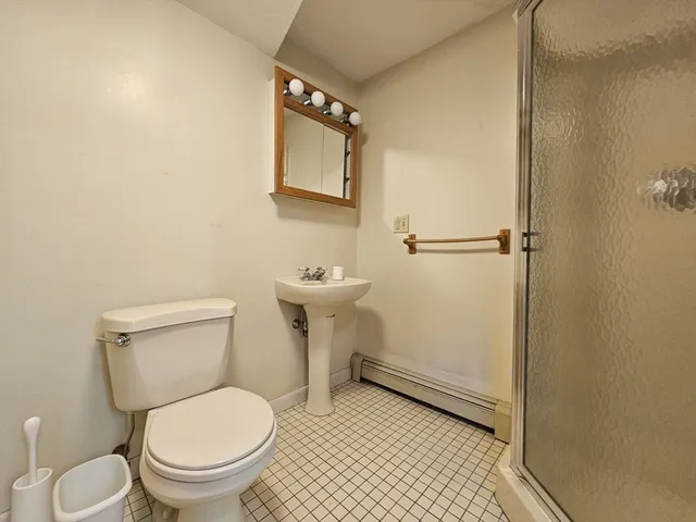 a white toilet sitting next to a bathroom sink