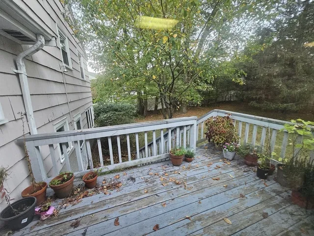 a view of deck with furniture and trees