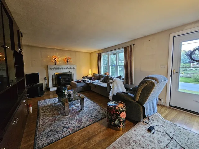 a living room with furniture a fireplace and a table
