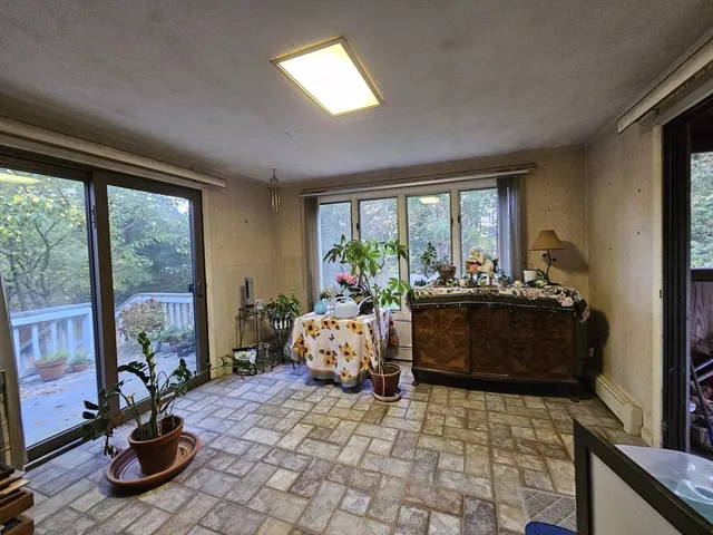 a bed room with furniture and a potted plant
