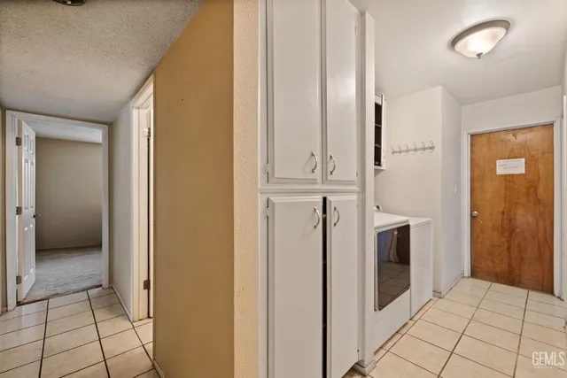 a view of a kitchen with white cabinets