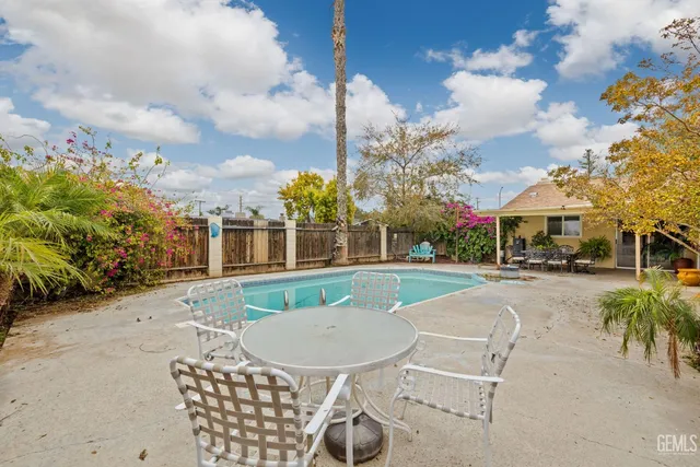 a view of a patio with a table and chairs