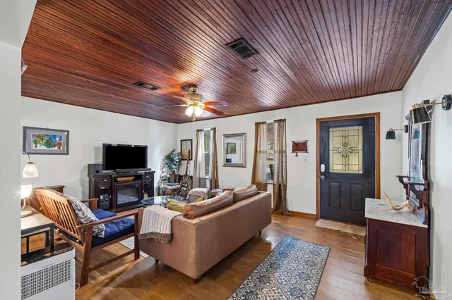 a living room with granite countertop furniture and a clock