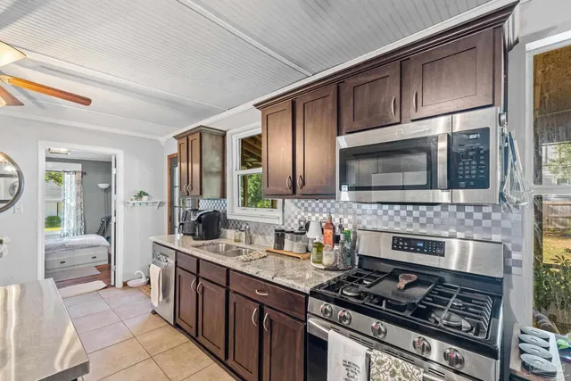 a kitchen with stainless steel appliances granite countertop a stove and a refrigerator