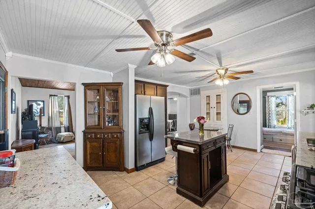 a kitchen with stainless steel appliances granite countertop a sink stove and cabinets