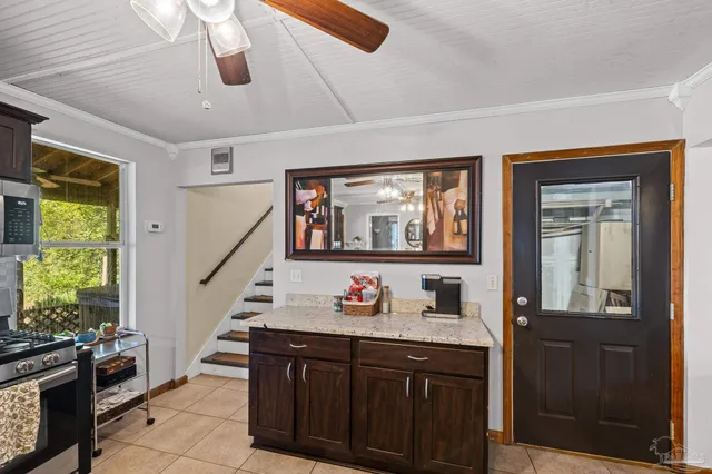 a living room with furniture flowerpot and a chandelier