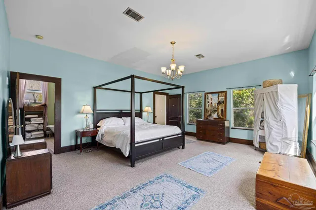 a view of a room with a large window and furniture