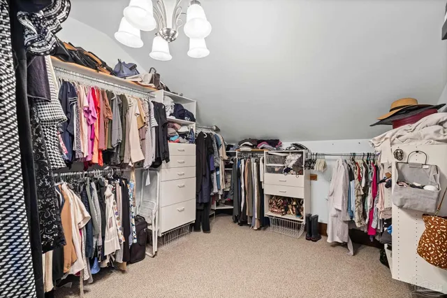 a bedroom with a bed and walk in closet