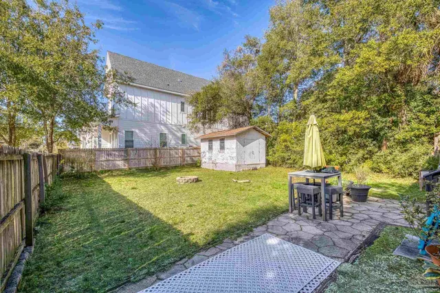 a view of backyard with patio