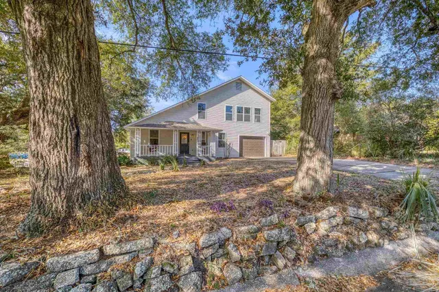 a house that has a tree in front of it