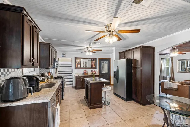 a living room with furniture a chandelier and a dining space