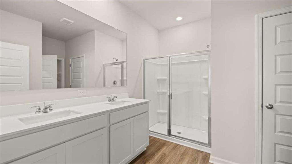 306 Friendship Oak Way Hampton, GA 30228 - Photo 23 of 41 a bathroom with a double vanity sink mirror and shower
