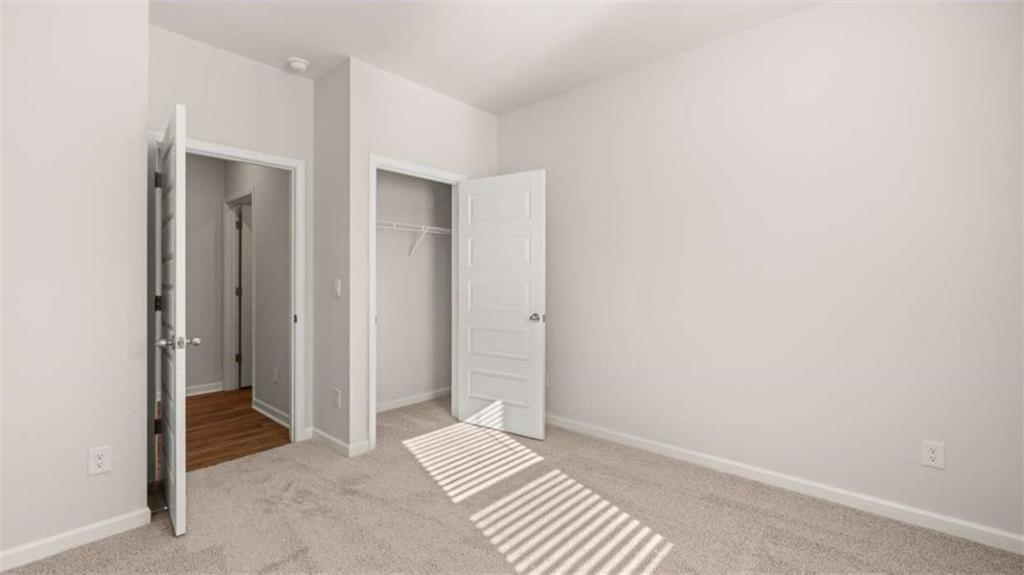 306 Friendship Oak Way Hampton, GA 30228 - Photo 30 of 41 a view of room with walk in closet and wooden floor