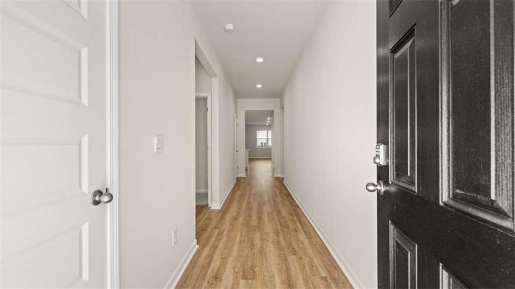 306 Friendship Oak Way Hampton, GA 30228 - Photo 4 of 41 a view of a hallway with wooden floor and staircase