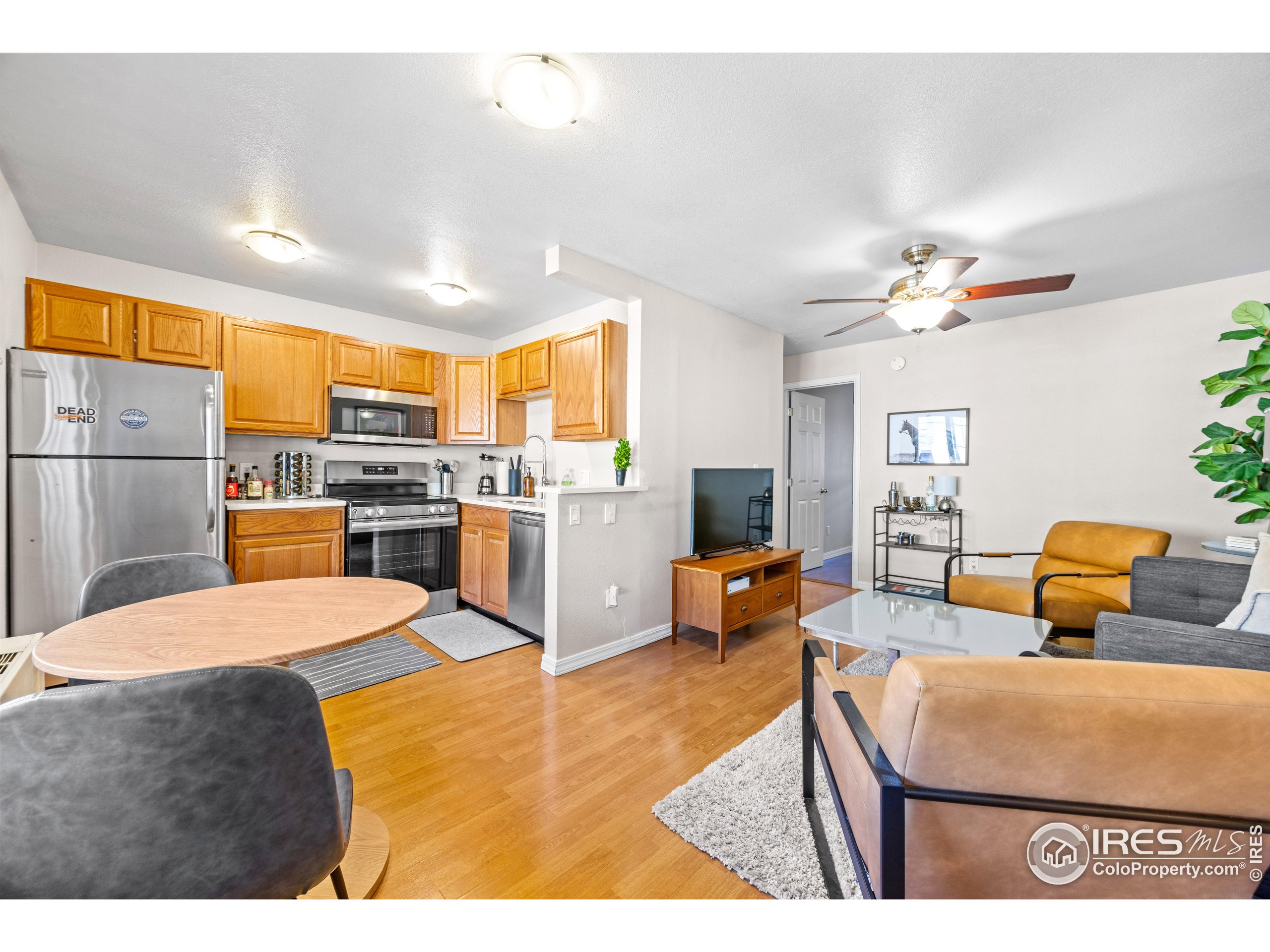 3009 Madison Avenue, Unit 315 Boulder, CO 80303 - Photo 12 of 17 a living room with stainless steel appliances kitchen island granite countertop furniture and a kitchen view