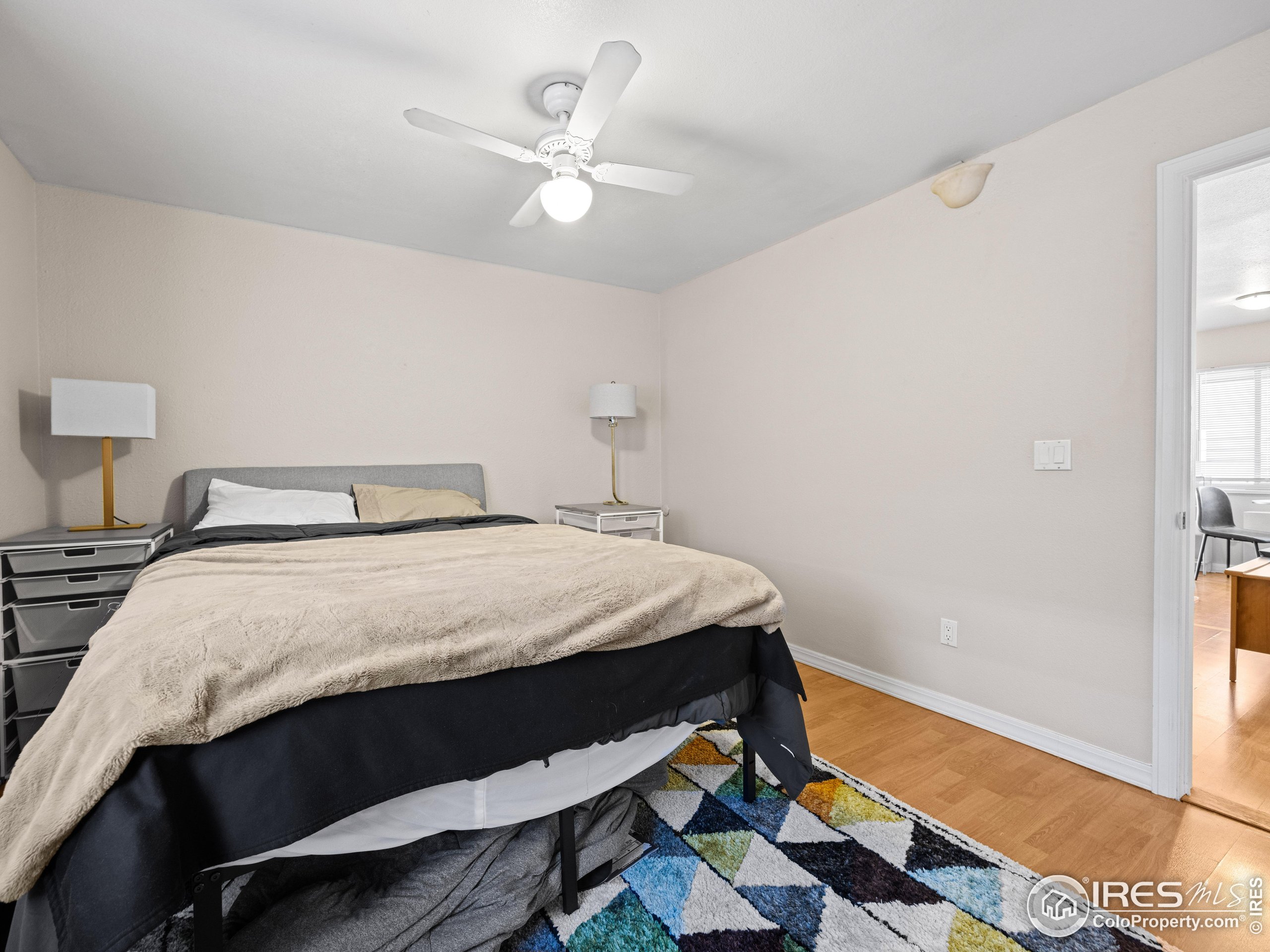 3009 Madison Avenue, Unit 315 Boulder, CO 80303 - Photo 15 of 17 a bed sitting in a bedroom next to a window