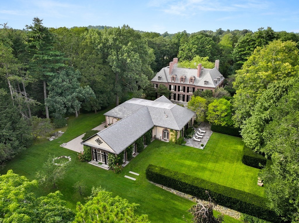 an aerial view of a house with swimming pool garden and couple of trees