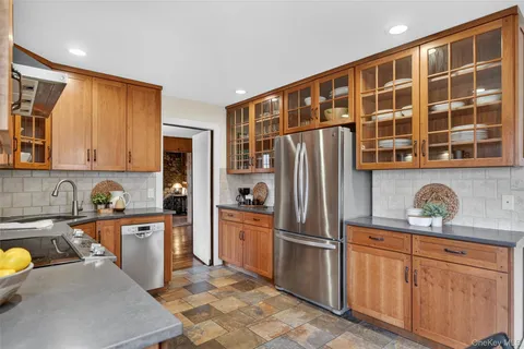 a kitchen with stainless steel appliances granite countertop a refrigerator and a stove top oven