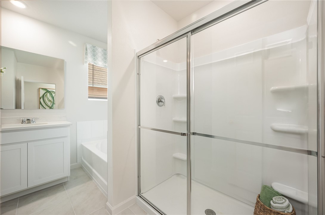 502 Saunders Street Sebastian, FL 32958 - Photo 19 of 30 a bathroom with a shower sink vanity and mirror