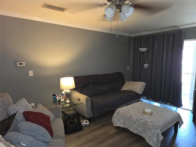a living room with furniture and a chandelier
